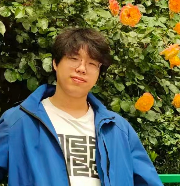 Jiawei Chen in a blue jacket in front of flowering roses
